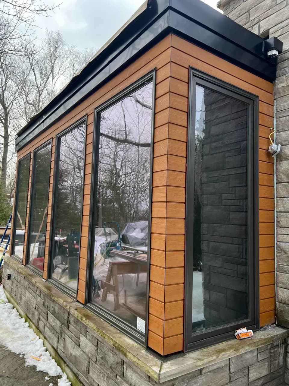 Cedar and black-framed window bay, exterior cladding