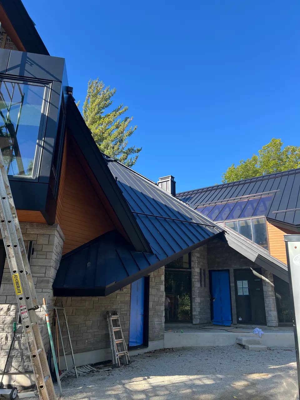 Angular metal roof with cedar-clad peak