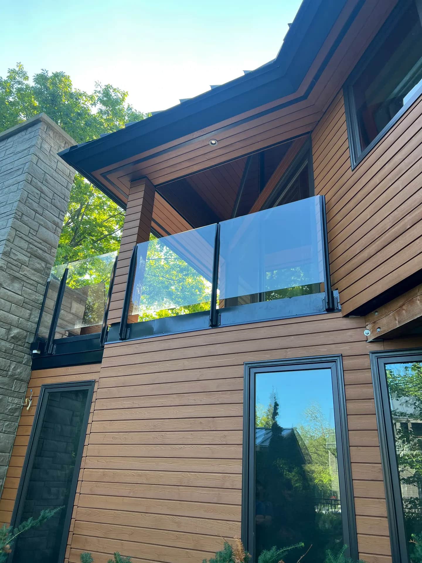 Multi-level cedar-clad modern home with glass balcony near Collingwood