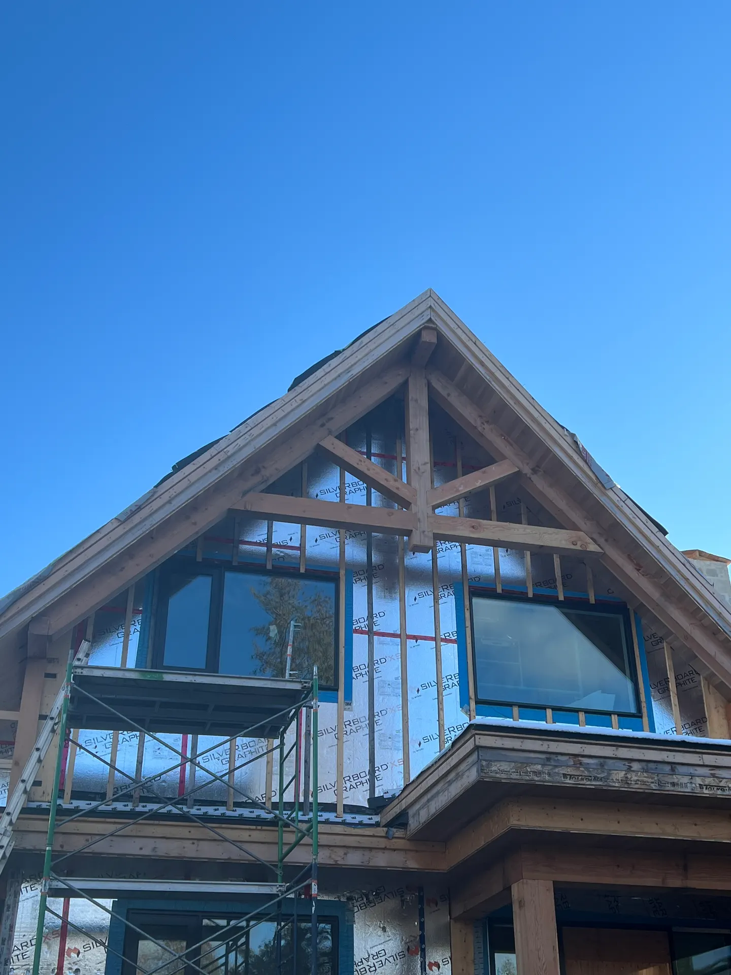 Timber-frame glass gable peak on a custom Wasaga Beach home