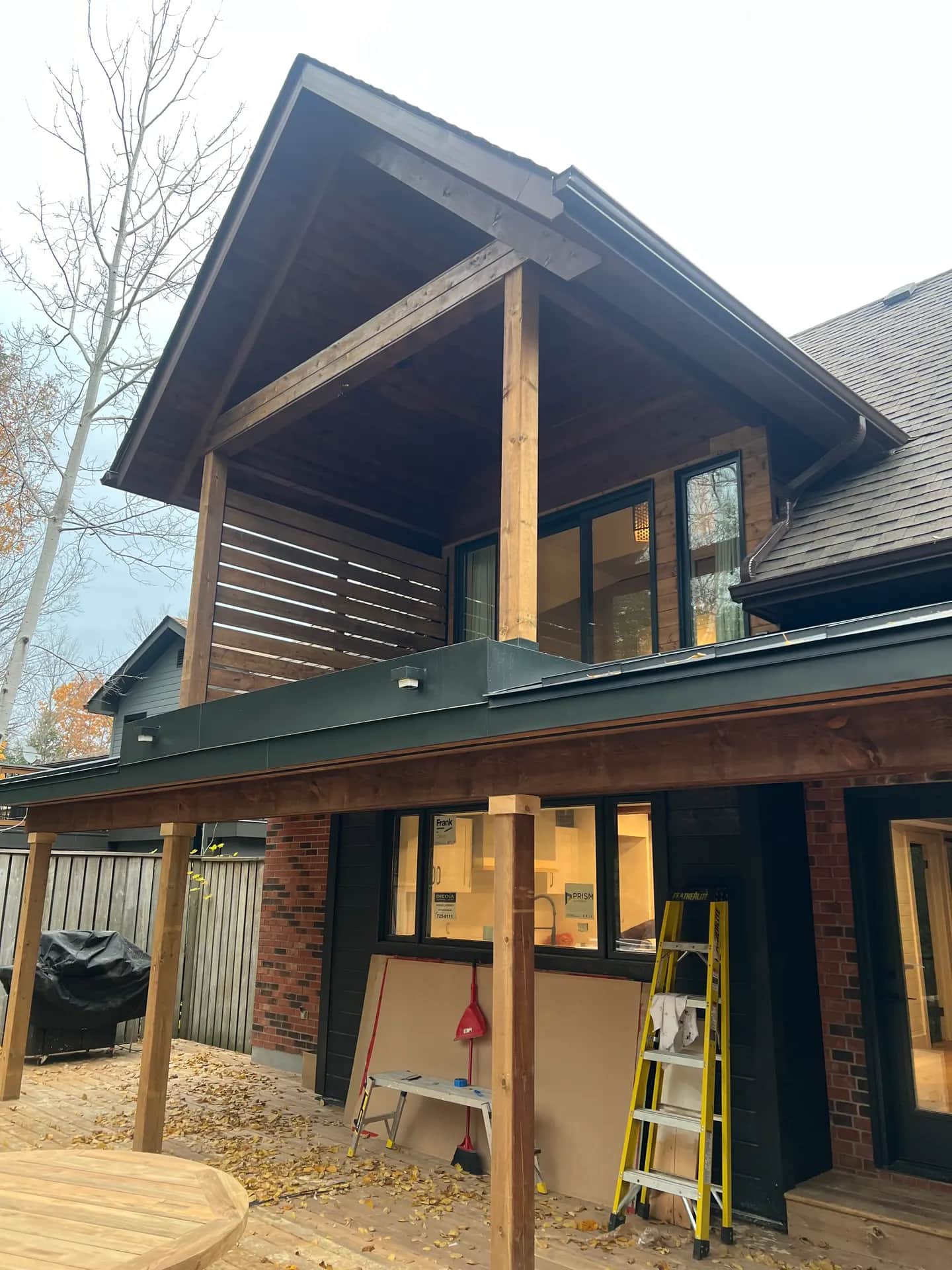Timber-frame covered porch on a finished custom home in Simcoe County